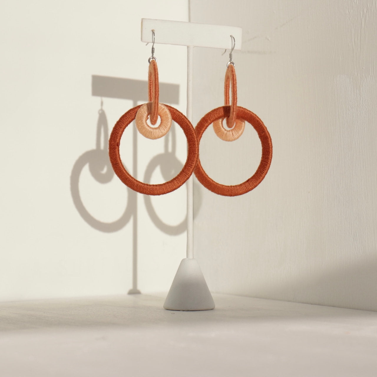 Close-up of the Jodee Statement Earrings, featuring interlocking loops that move with intention. A handcrafted piece designed in Houston for effortless expression.
