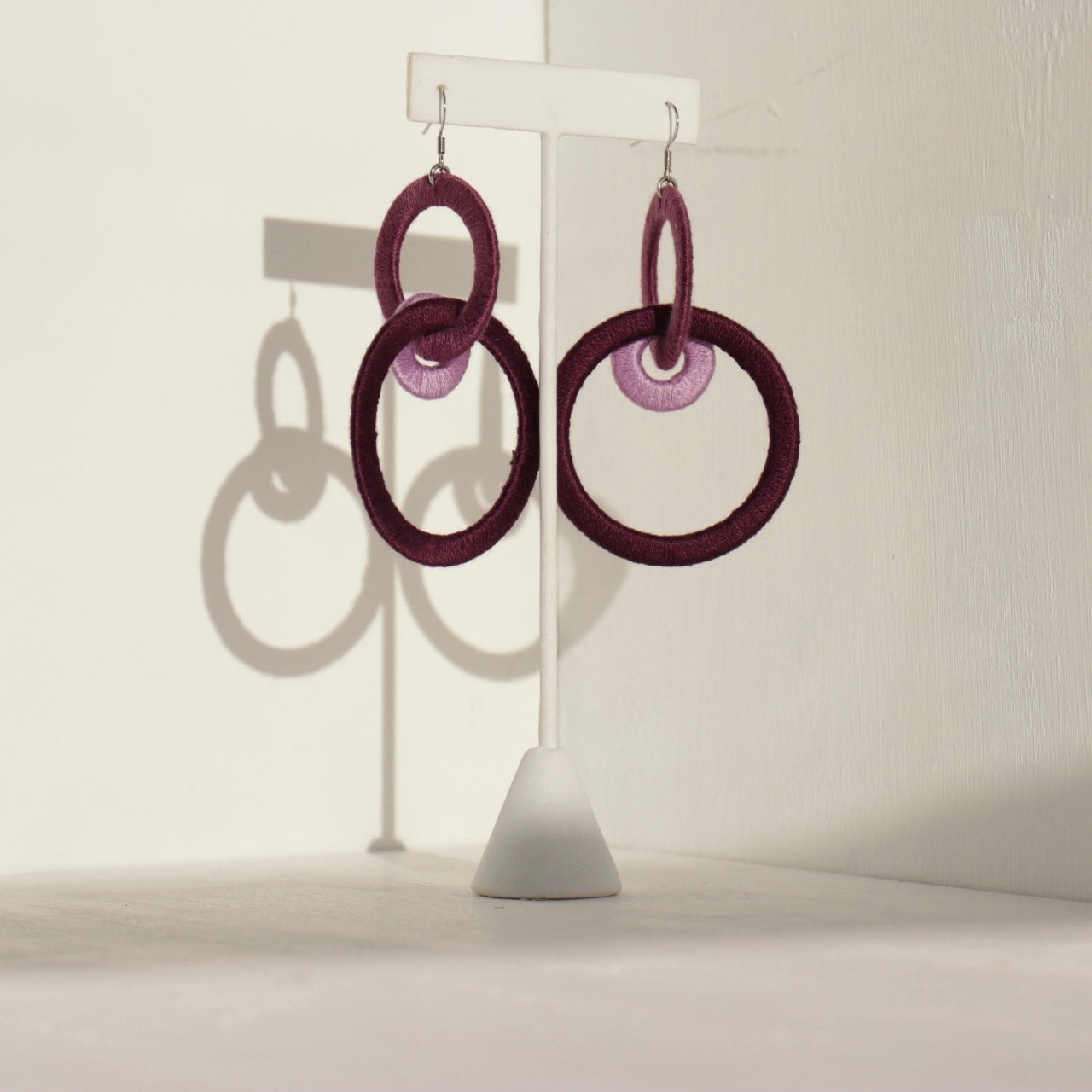 Close-up of the Jodee Statement Earrings, featuring interlocking loops that move with intention. A handcrafted piece designed in Houston for effortless expression.