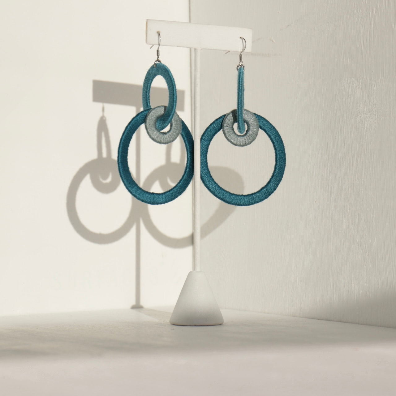 Close-up of the Jodee Statement Earrings, featuring interlocking loops that move with intention. A handcrafted piece designed in Houston for effortless expression.