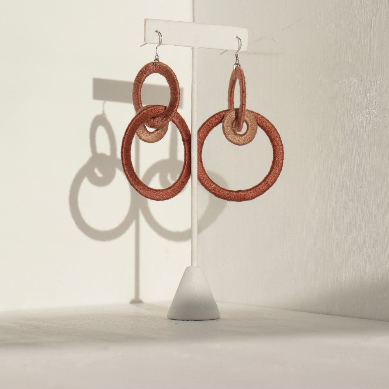 Close-up of the Jodee Statement Earrings, featuring interlocking loops that move with intention. A handcrafted piece designed in Houston for effortless expression.
