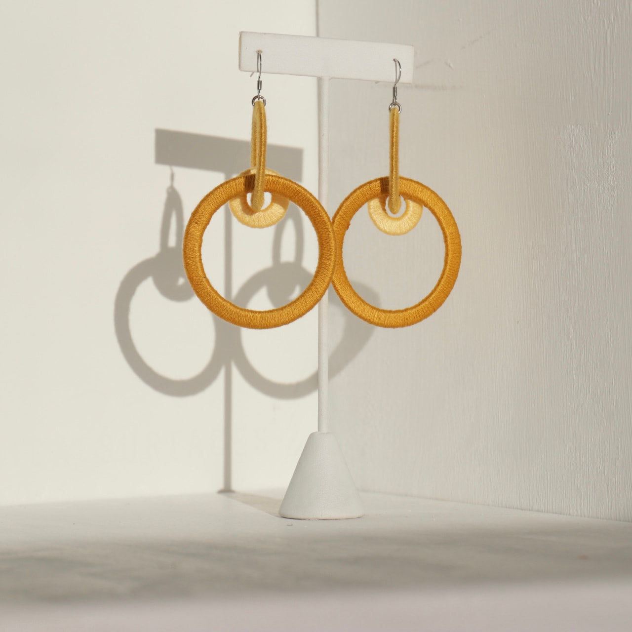 Close-up of the Jodee Statement Earrings, featuring interlocking loops that move with intention. A handcrafted piece designed in Houston for effortless expression.