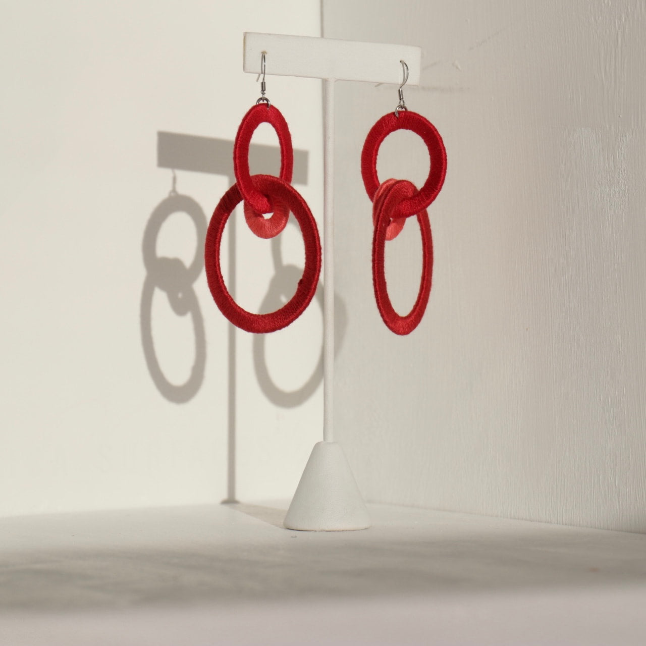 Close-up of the Jodee Statement Earrings, featuring interlocking loops that move with intention. A handcrafted piece designed in Houston for effortless expression.