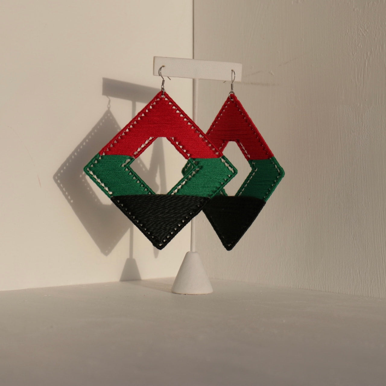 Close-up of The Joel earrings showcasing their angular geometric design
