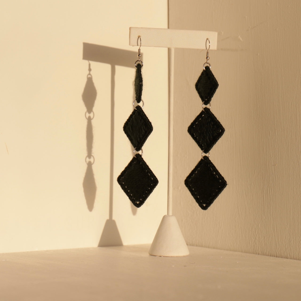 Black Kambi earrings, where craftsmanship meets modern structure in a timeless cascading form