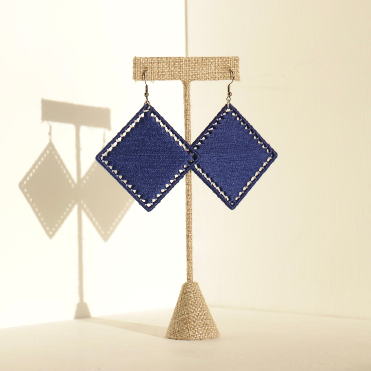 The Kwame earrings in classic navy, bringing a sophisticated edge to any look