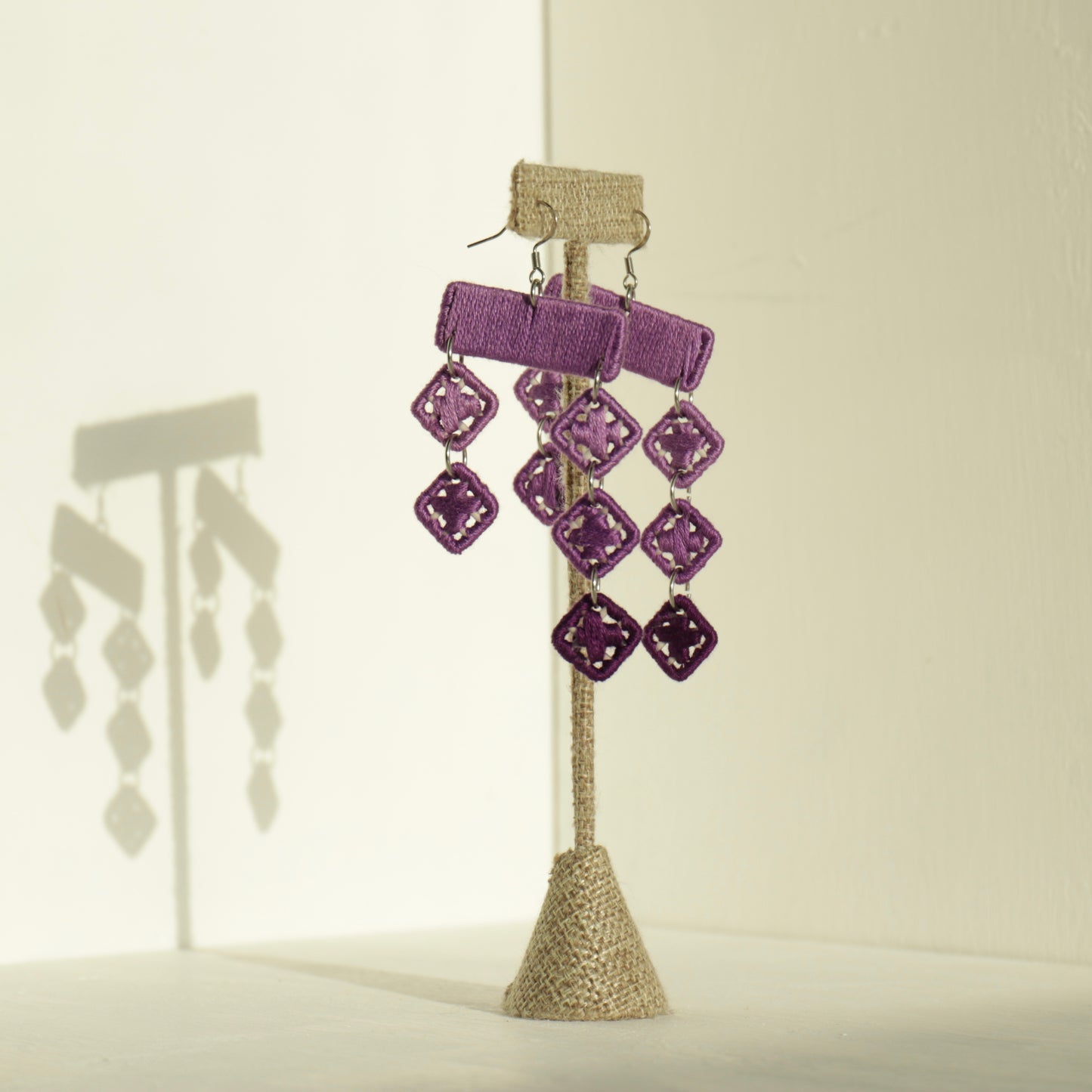 The Finesse earrings in purple by OlaNti, a structured yet fluid statement piece