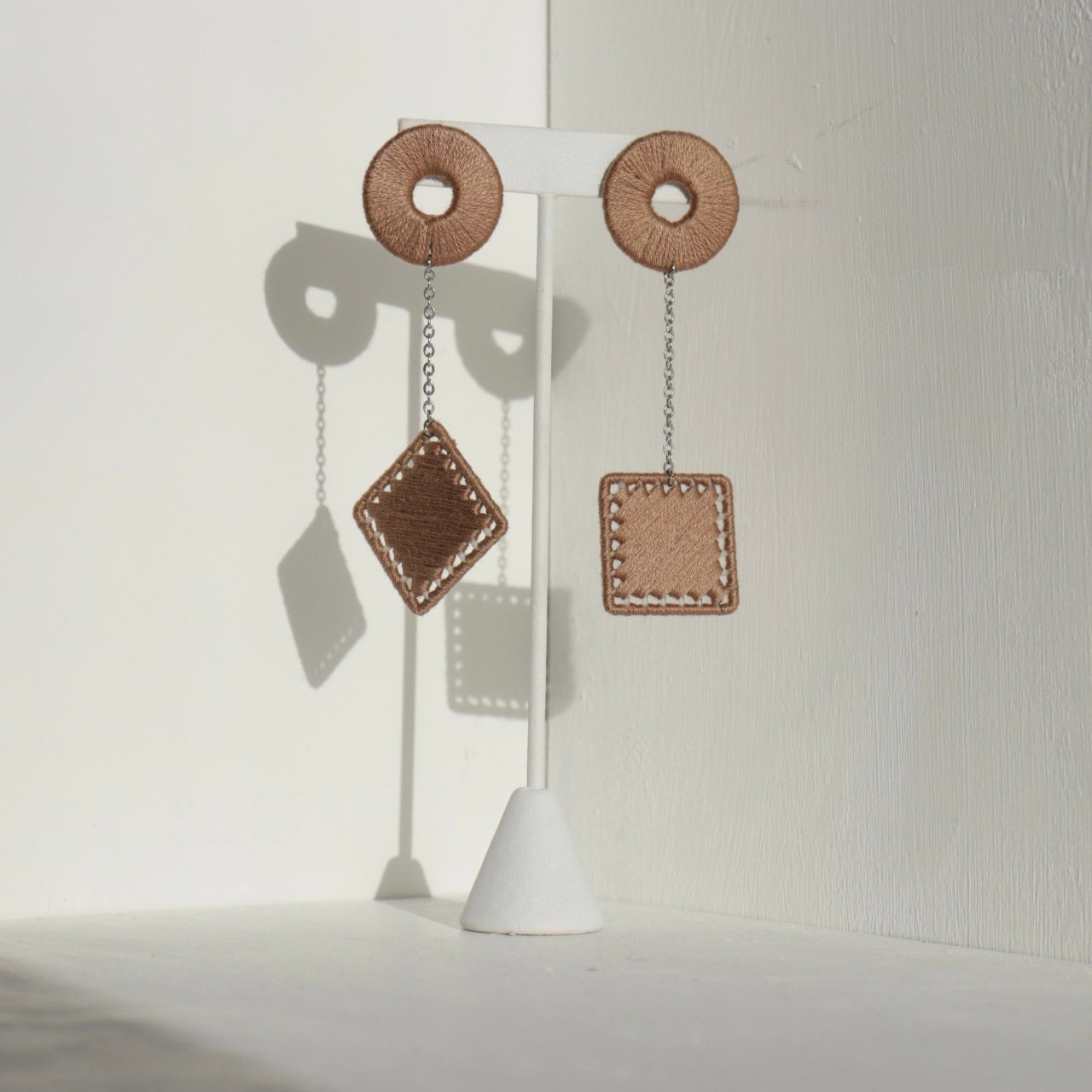 The Klowii earrings in brown by OlaNti Houston, a neutral-toned contemporary design