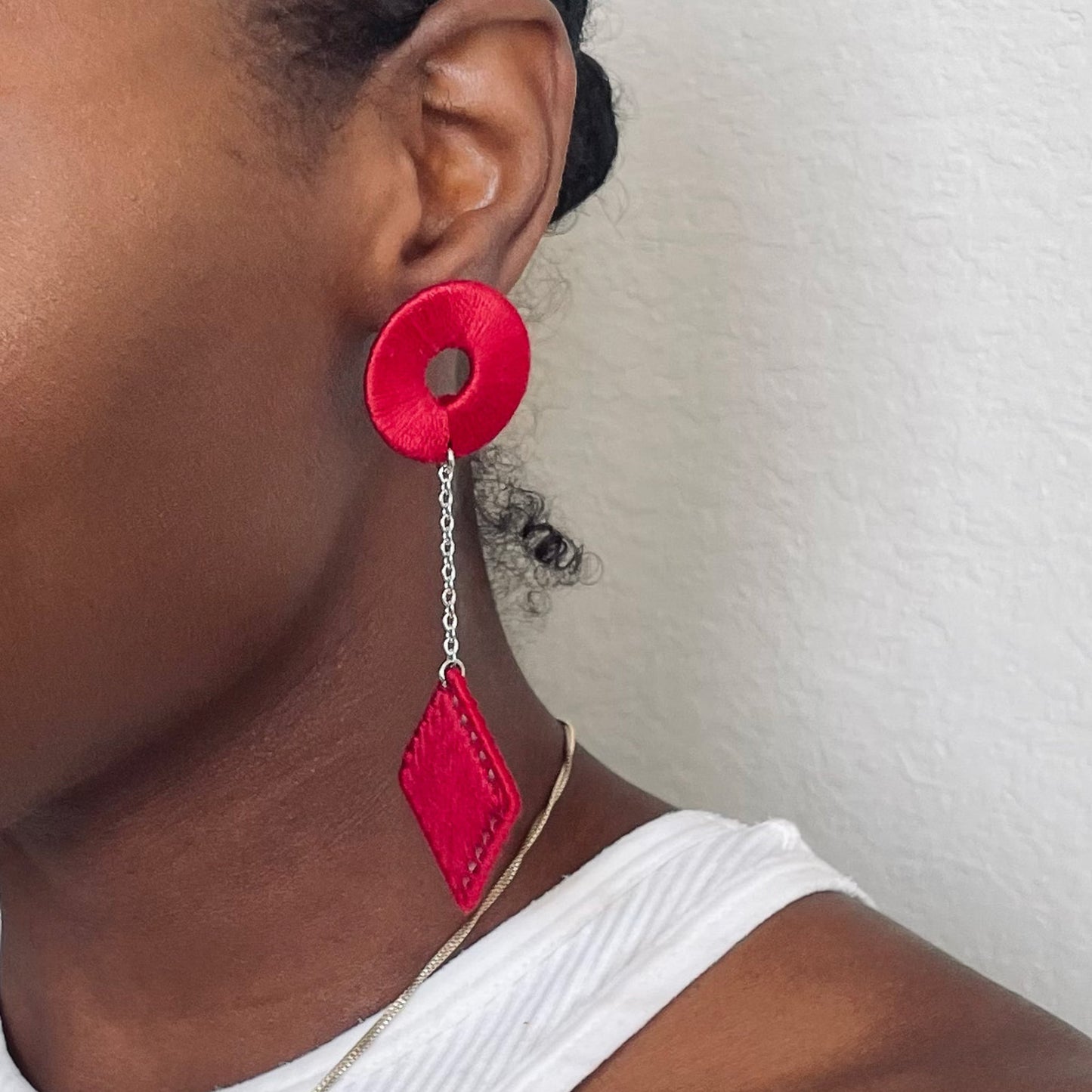 The Klowii earrings in deep red by OlaNti Houston, striking yet elegant.