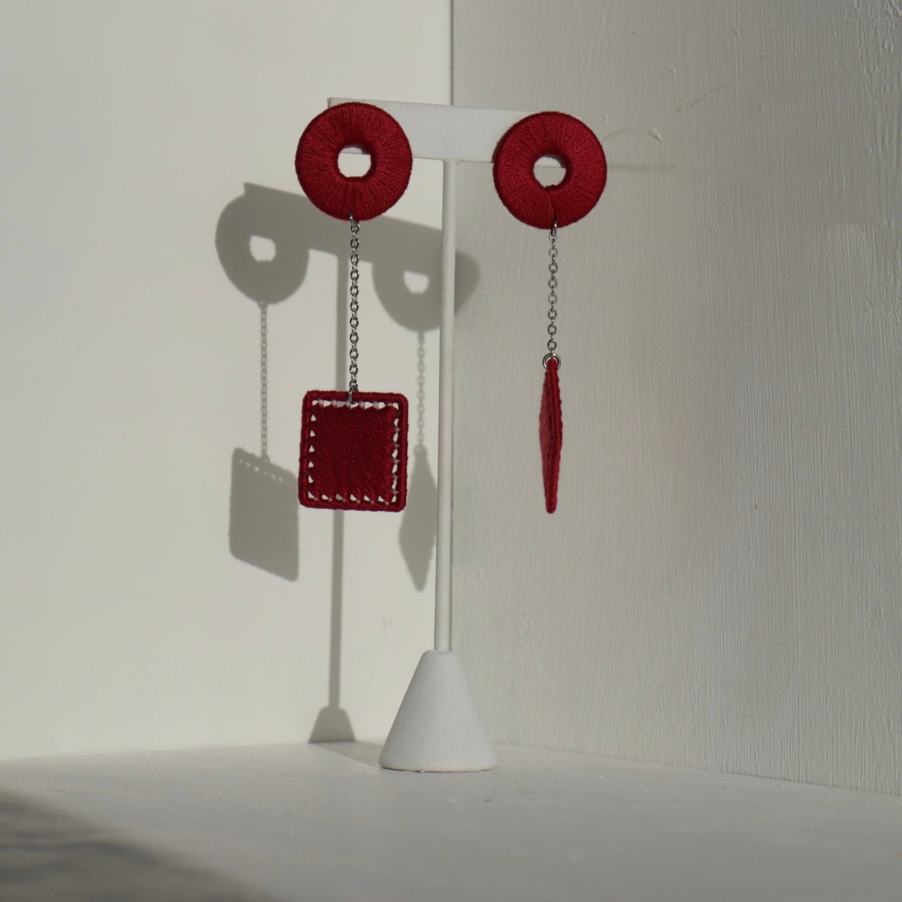 The Klowii earrings in maroon by OlaNti Houston, a rich color with a structured aesthetic