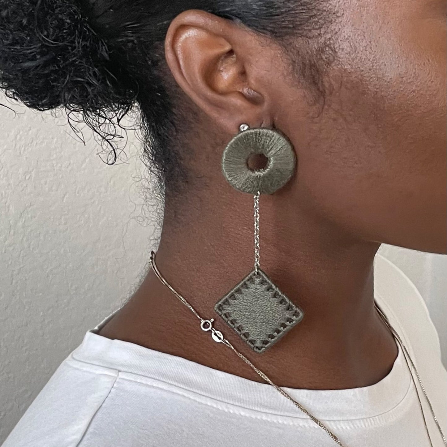 The Klowii earrings in muted olive by OlaNti Houston, a contemporary and versatile design.