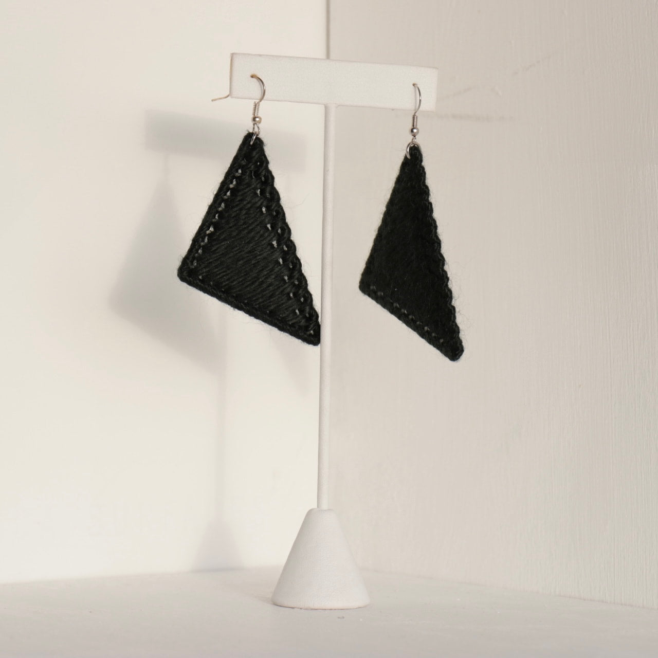 The Kofi earrings in black by OlaNti Houston, a deep, defined triangular earring