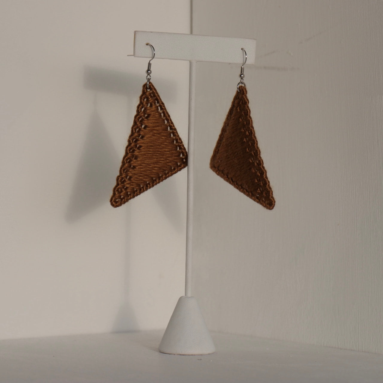 The Kofi earrings in rich brown by OlaNti Houston, blending earthy tones with structure