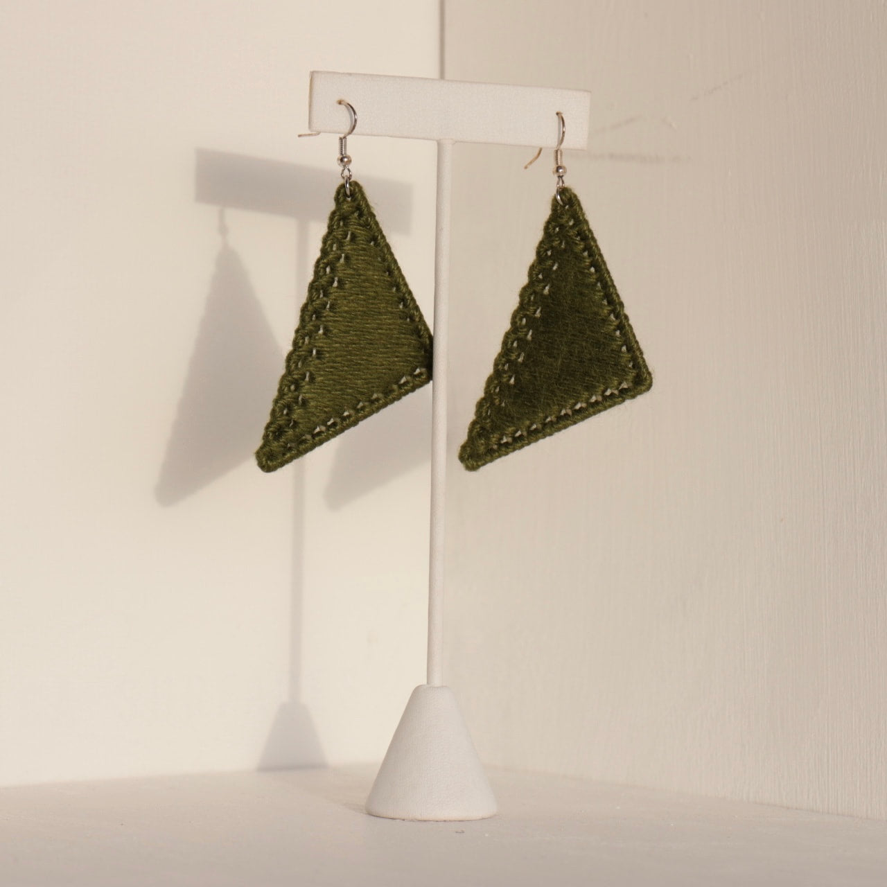 The Kofi earrings in olive green by OlaNti Houston, perfect for an effortless statement