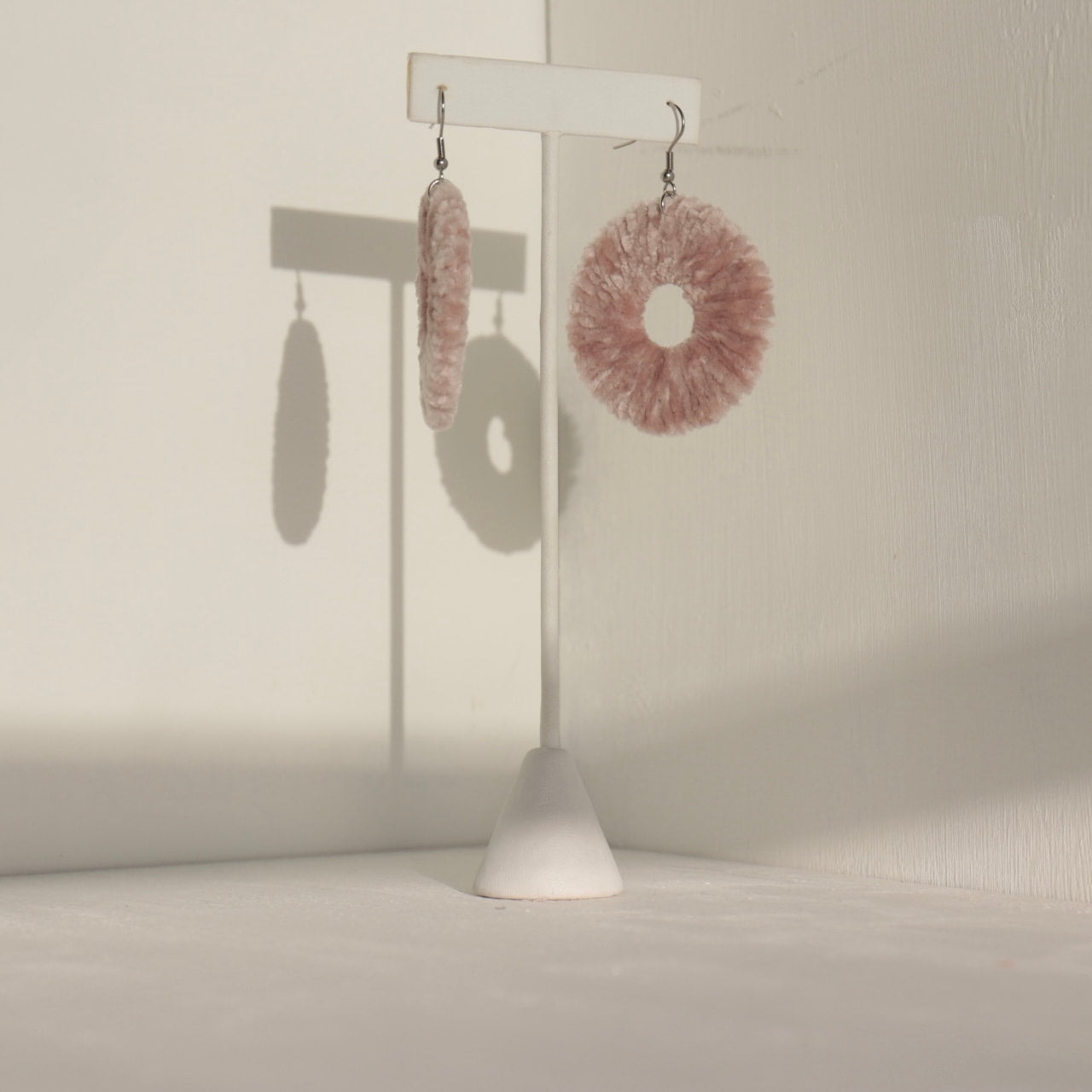 The Vinny earrings in a side-profile shot, showcasing their lightweight movement and unique texture