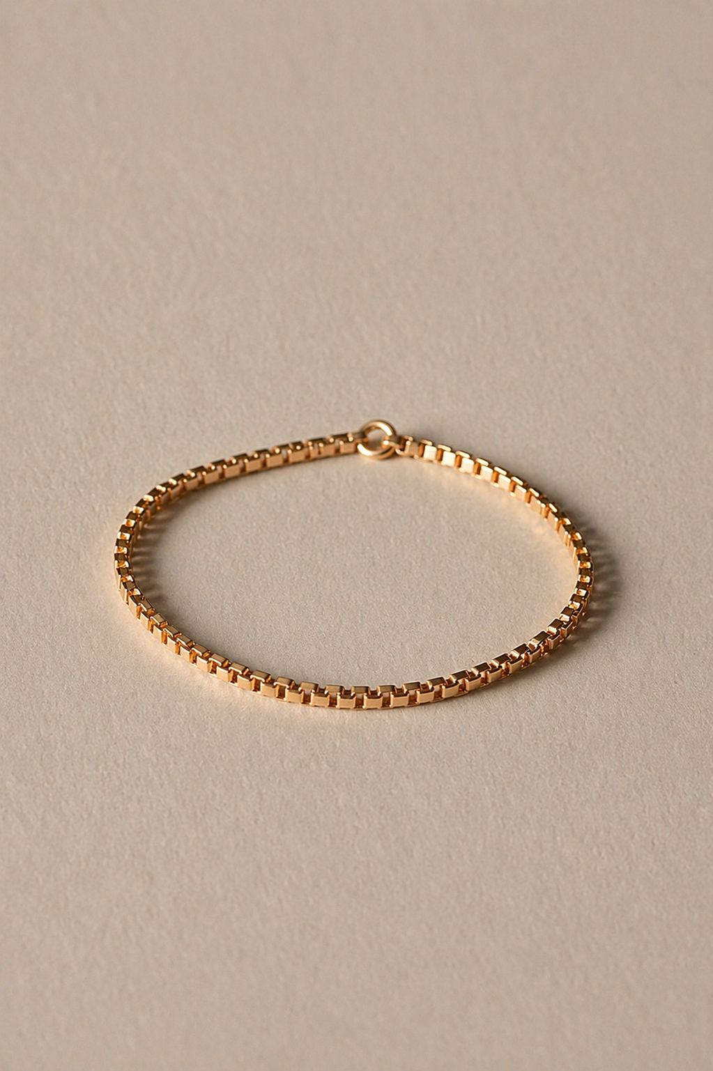 Gold Chain Ring on a beige background