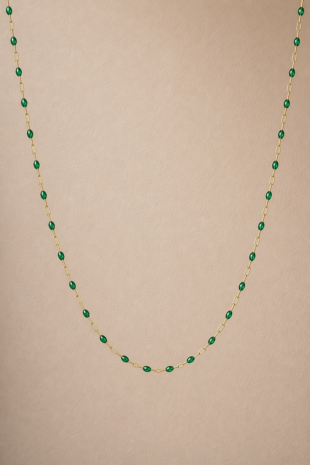Necklace with green beads on a beige background