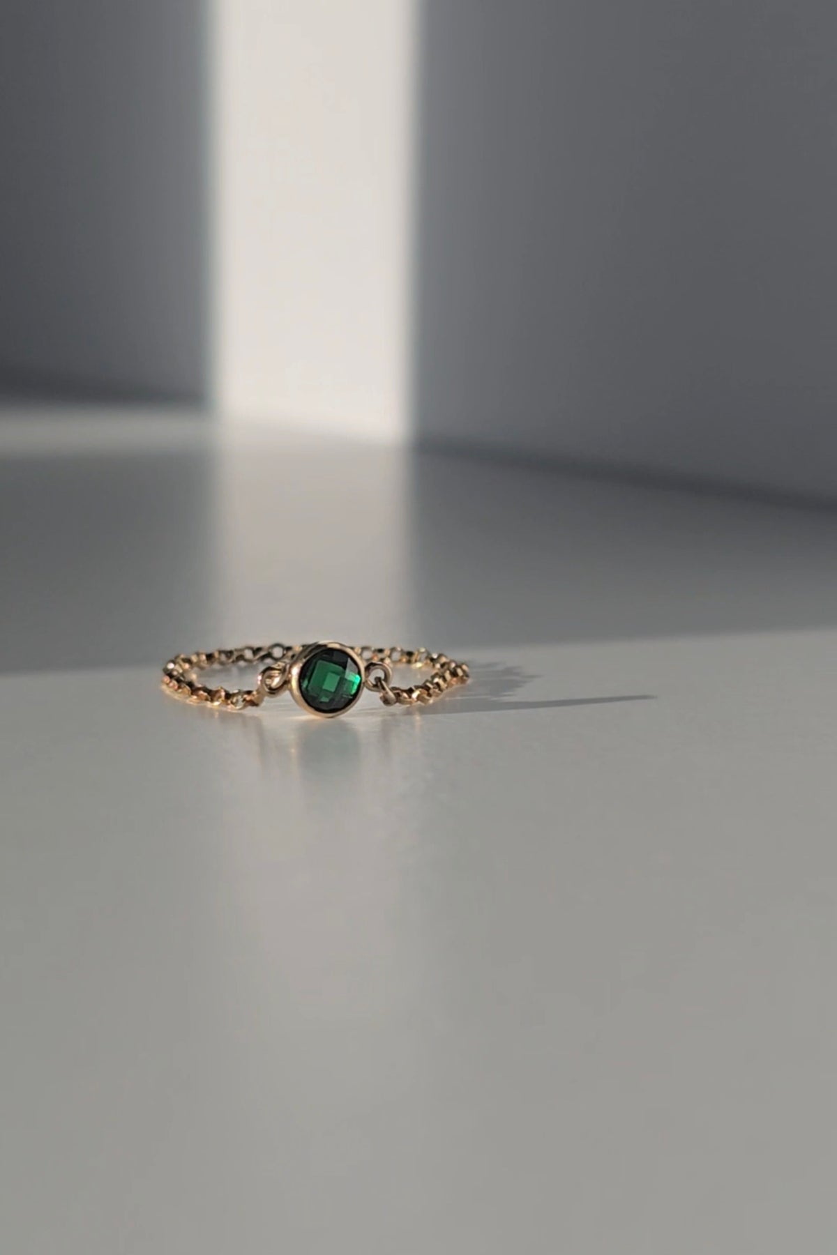 Gold chain ring on neutral base