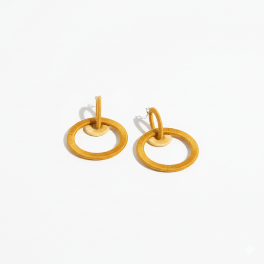 Pair of yellow hoop earrings on a white background