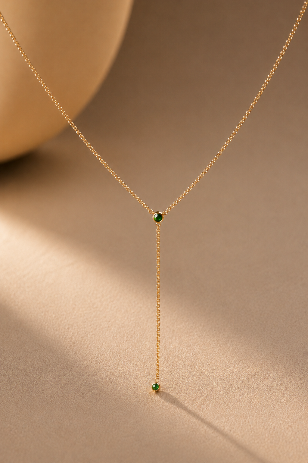 Gold lariat necklace with green crystals