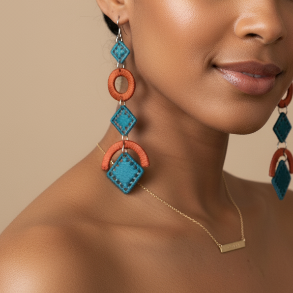 Woman wearing colorful earrings against a beige background
