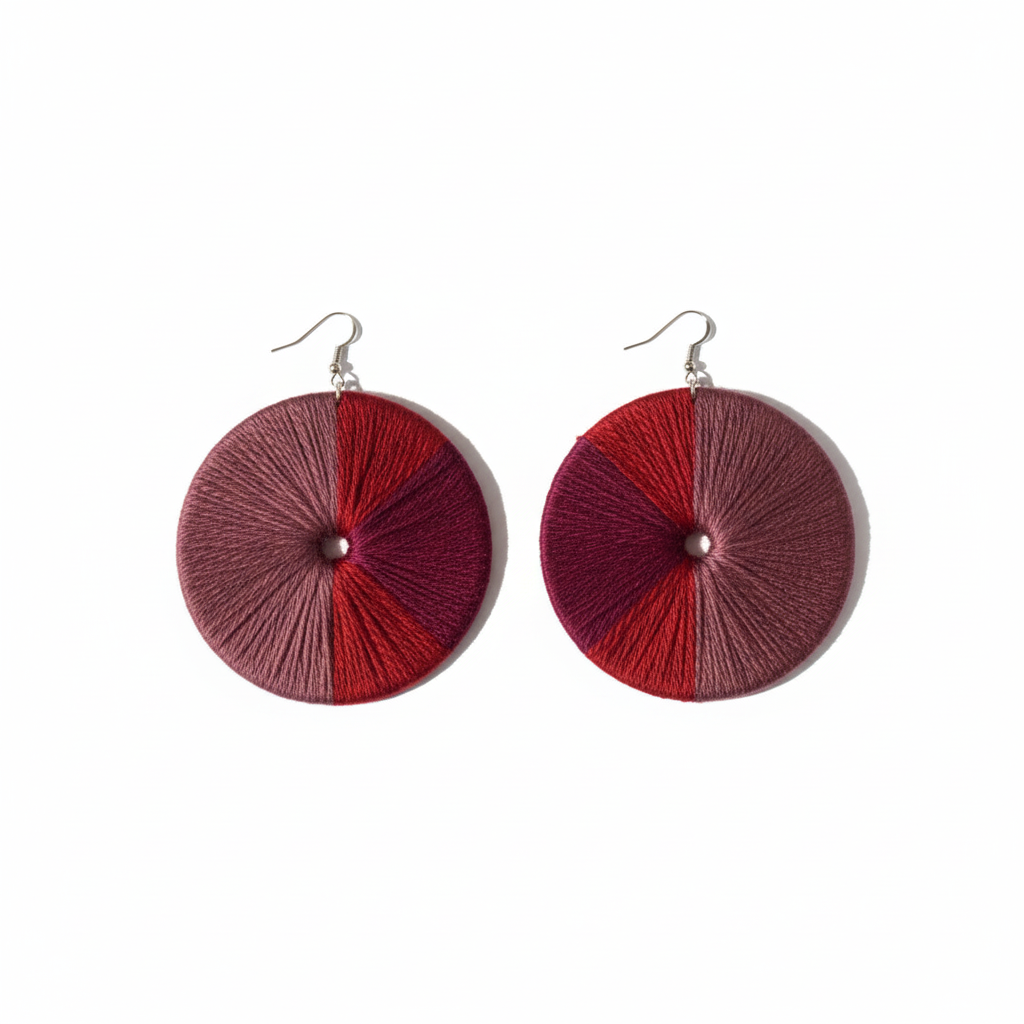 Pair of round earrings with red and pink gradient design on a white background