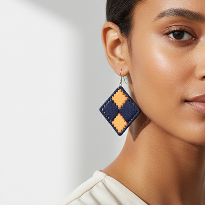 Woman wearing geometric earrings against a neutral background