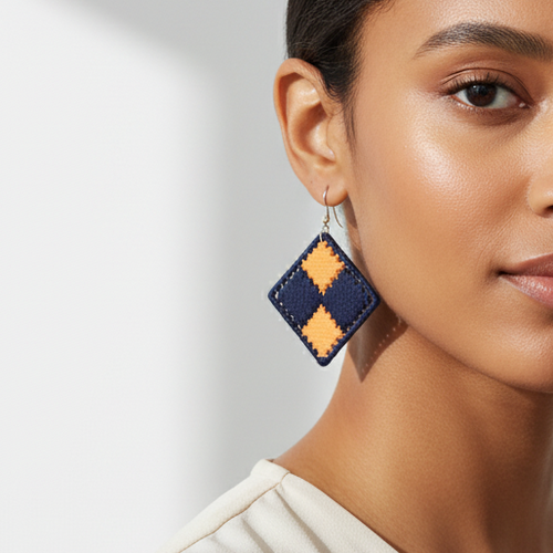 Woman wearing geometric earrings against a neutral background