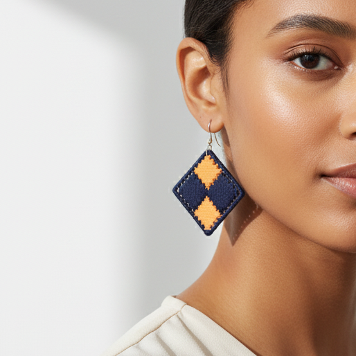 Woman wearing geometric earrings against a neutral background
