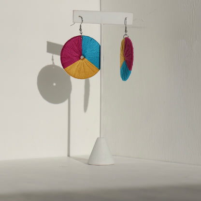 The Bode earrings in a bold yellow pink and blue colorway, displayed against a neutral background.