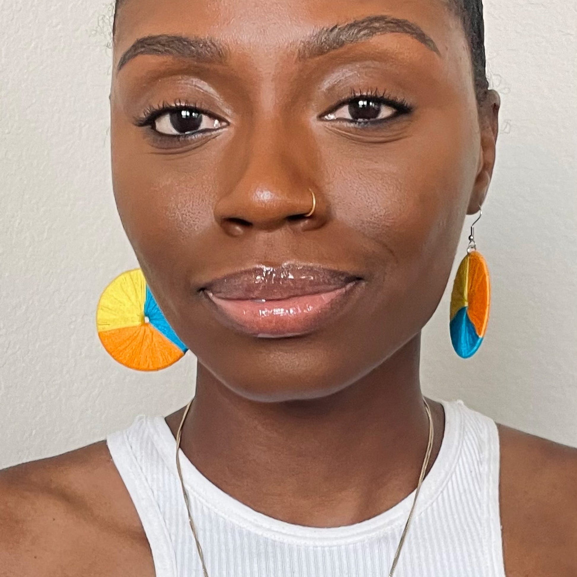 Model wearing The Bode earrings in a front-facing portrait, showcasing their statement design