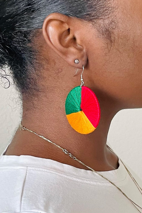 Model wearing The Bode earrings in a side profile, showcasing the colorblock design