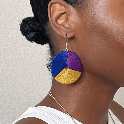 Model wearing The Bode earrings in a side profile, capturing their vibrant hues and movemen