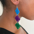 Side profile of a model wearing The Bunmi earrings, capturing their fluid movement