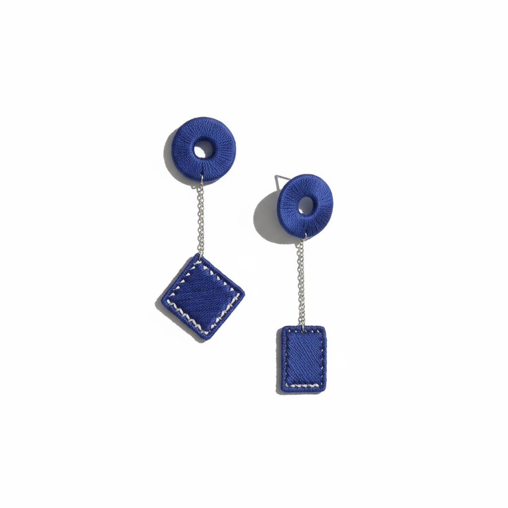 Blue earrings with circular and square designs on a white background