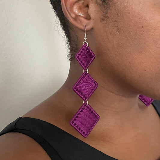 Purple Kambi earrings, an artful statement piece with a cascading geometric silhouette.