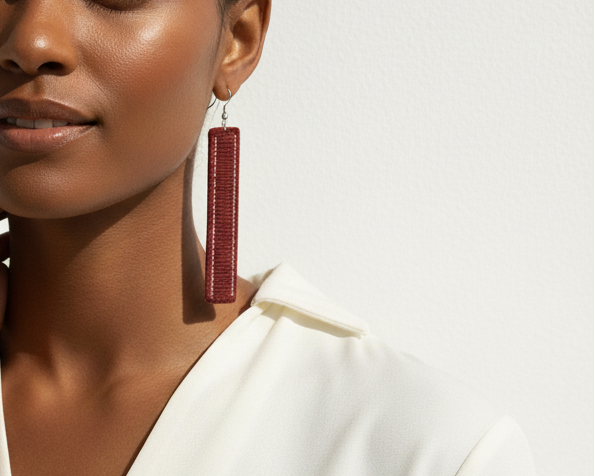 Woman wearing red earrings against a white background