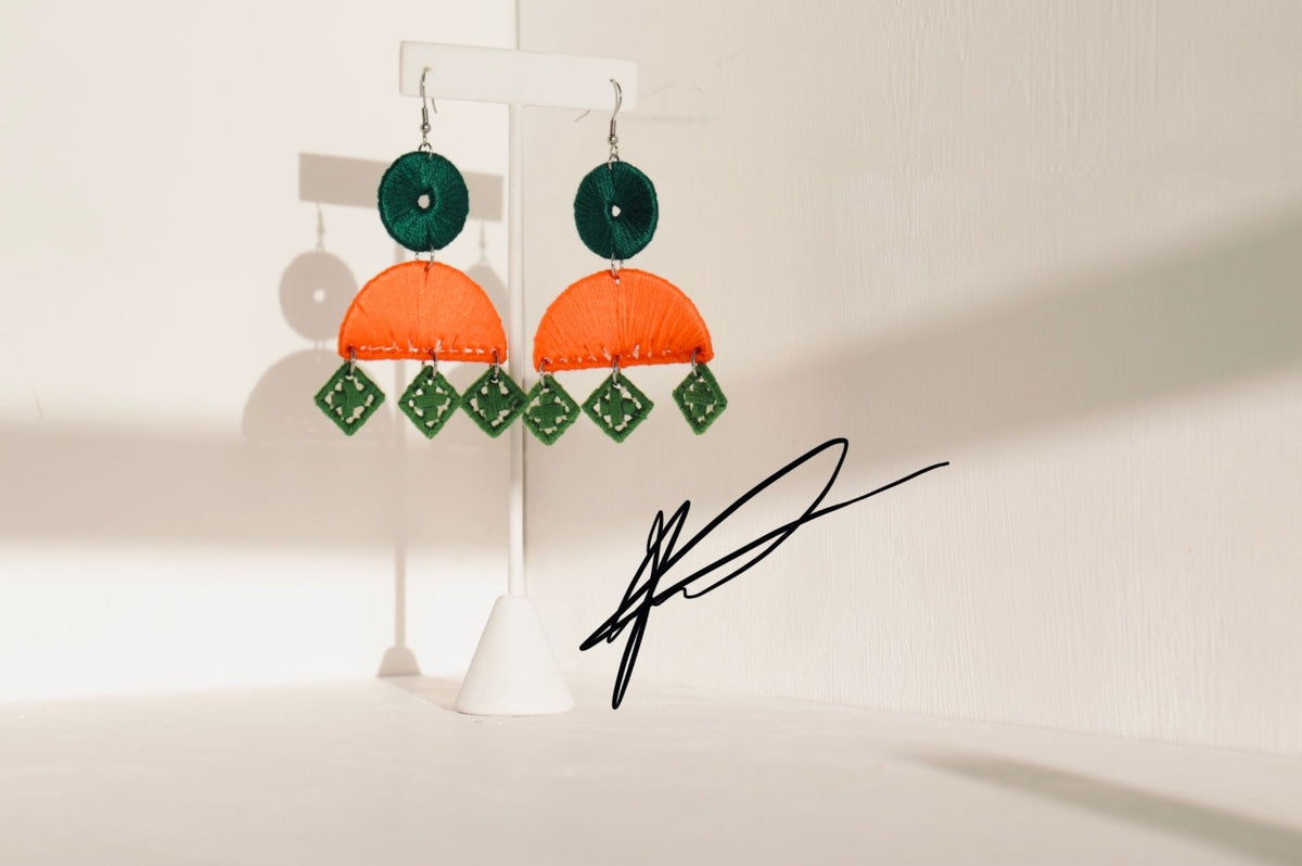 OLANTI statement earrings photographed in warm directional light