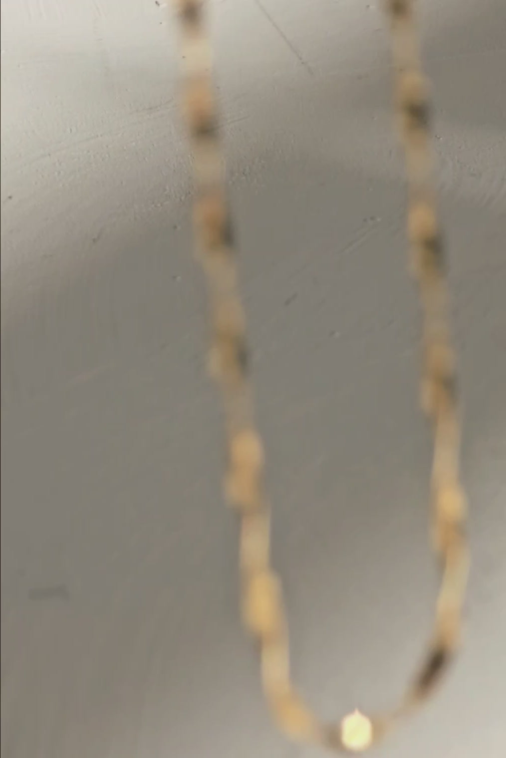 Amara 14K solid gold twisted chain necklace by OLANTI, showing the chain's dimensional link design.