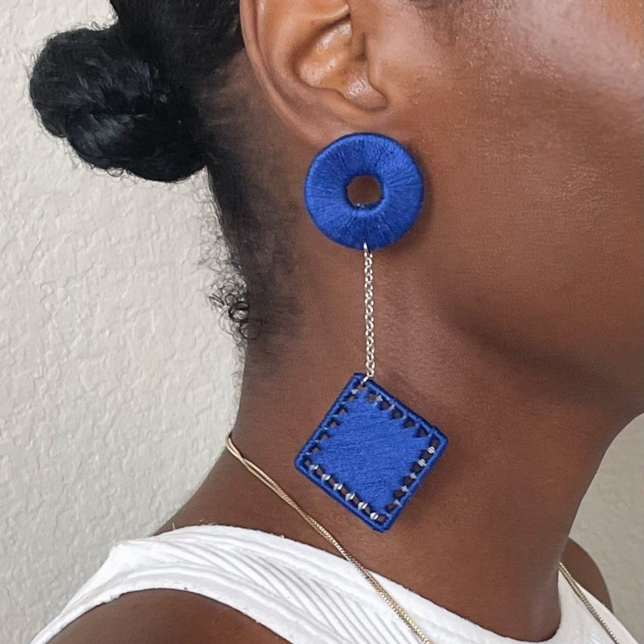The Klowii earrings in blue by OlaNti Houston, featuring geometric circular and square elements