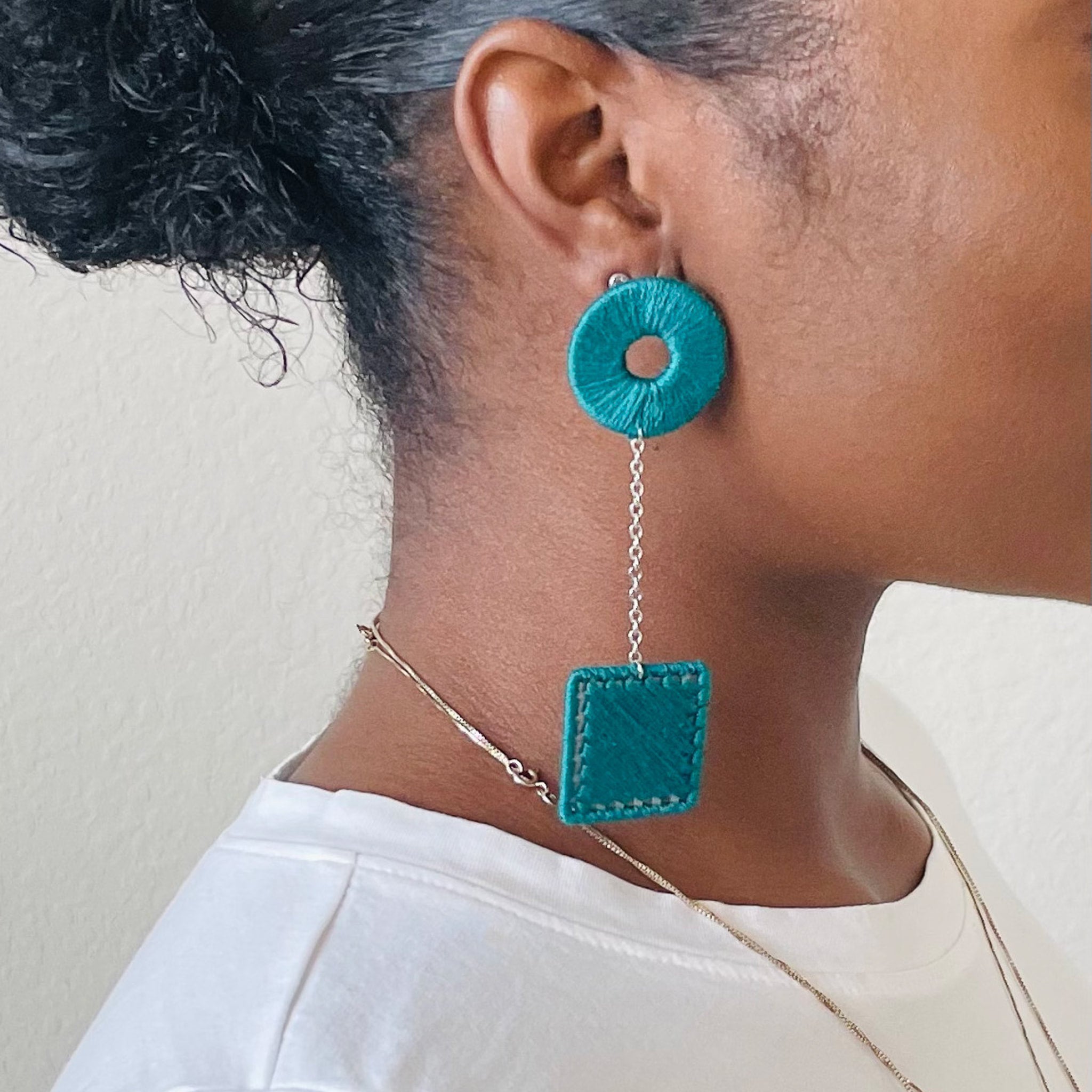 The Klowii earrings in teal by OlaNti Houston, capturing modern sophistication