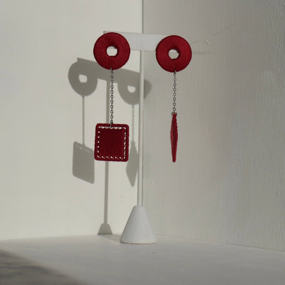 The Klowii earrings in maroon by OlaNti Houston, a rich color with a structured aesthetic
