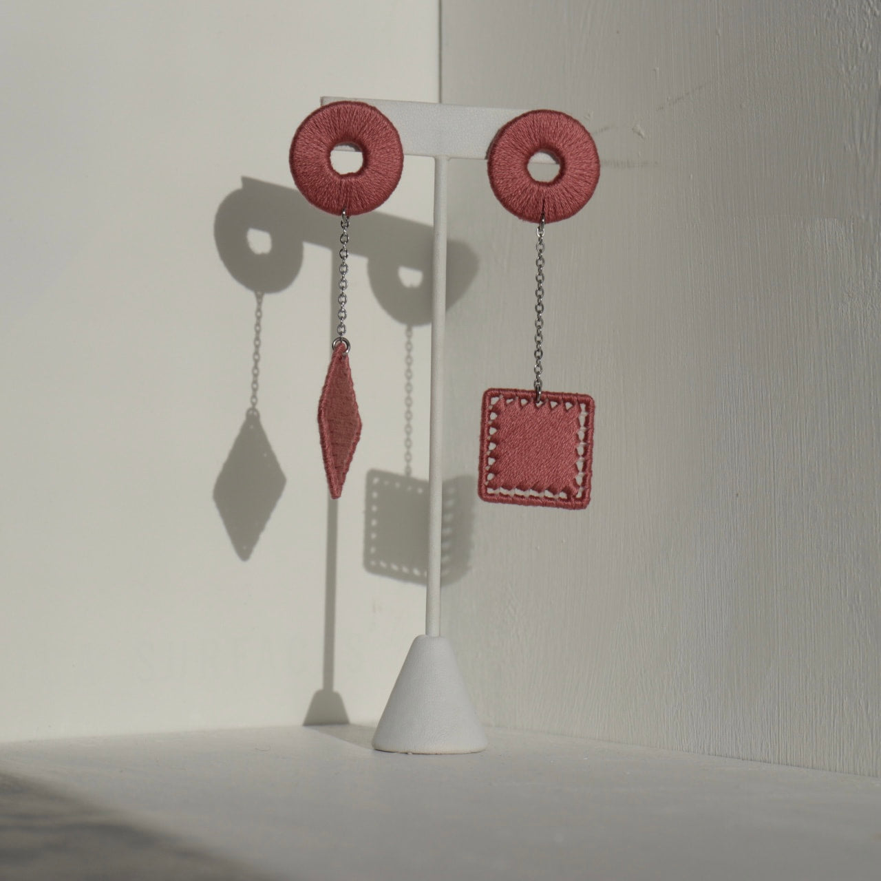 The Klowii earrings in pink by OlaNti Houston, featuring geometric circular and square elements with gradient coloring