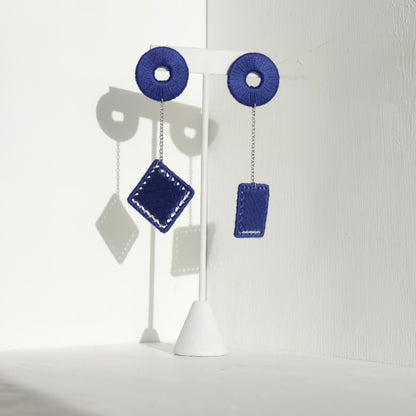 The Klowii earrings in blue by OlaNti Houston, featuring geometric circular and square elements