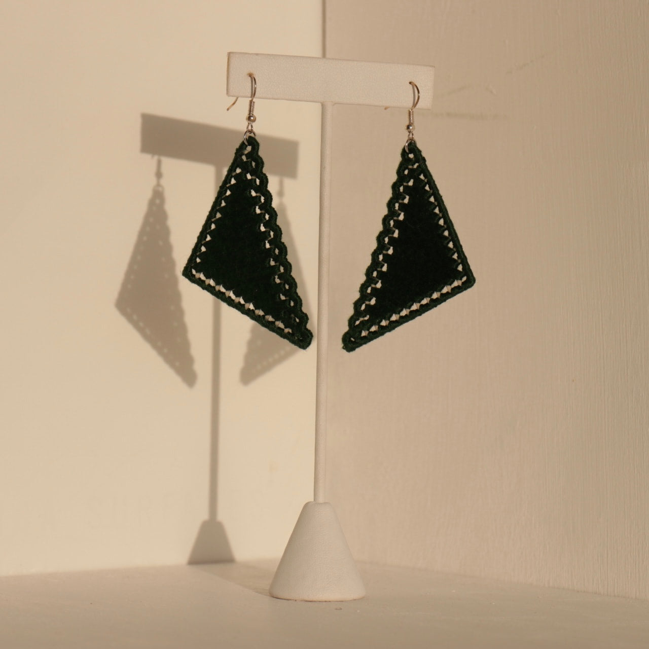 The Kofi earrings in deep green by OlaNti Houston, a bold triangular design