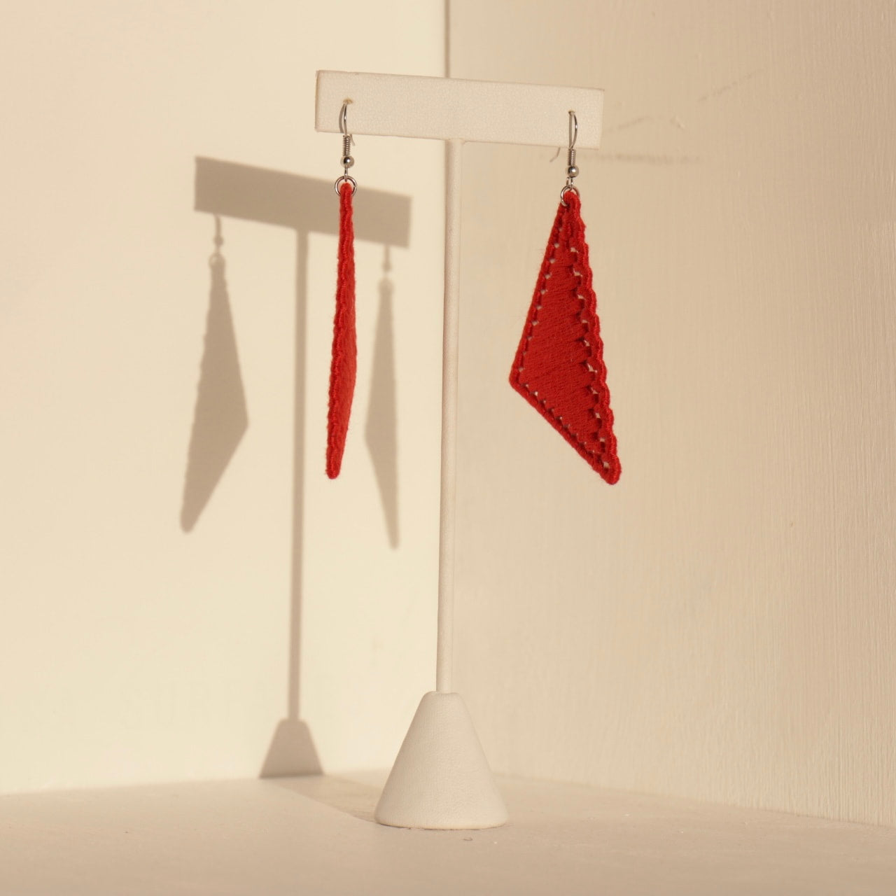 The Kofi earrings in red by OlaNti Houston, a striking geometric statement