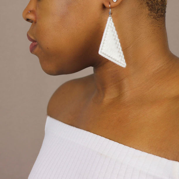 The Kofi earrings in white by OlaNti Houston, sharp yet understated in form