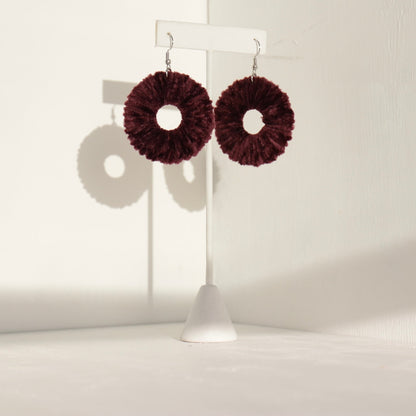 Burgundy Vinny earrings, highlighting their soft texture and handcrafted details.